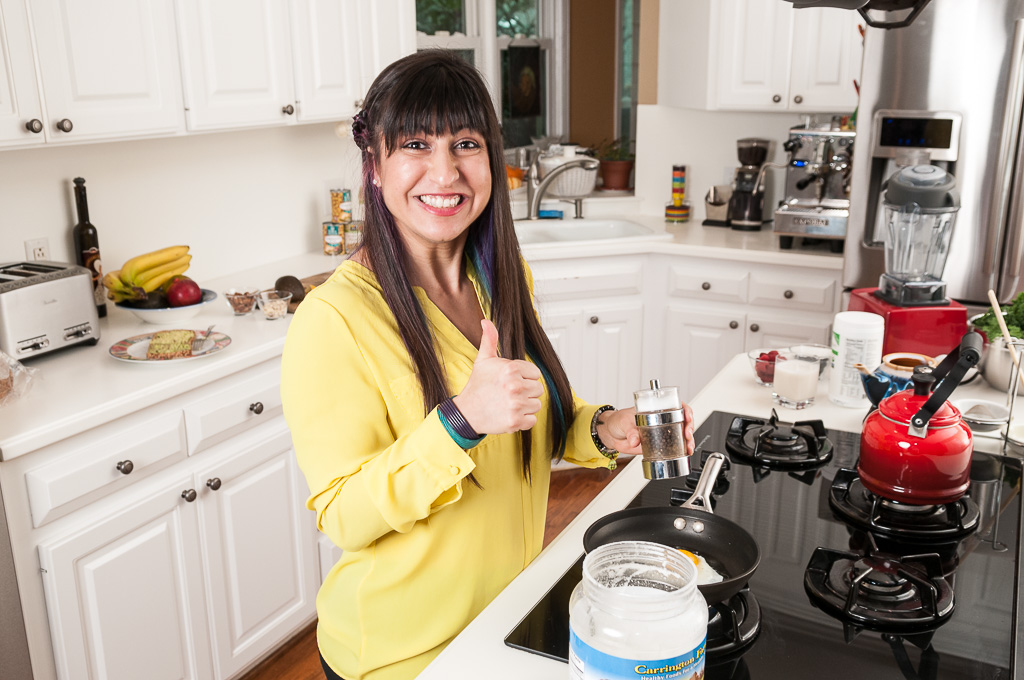 Parastoo in a yellow shirt giving thumbs up over a stove cooking eggs