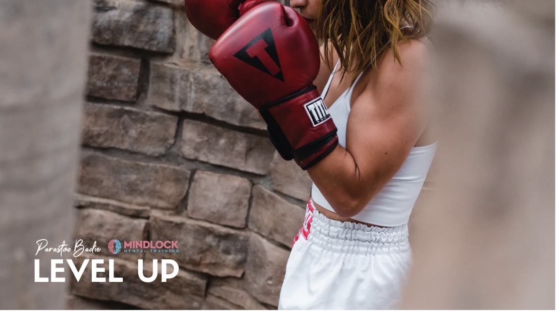 Parastoo Badie in boxing gloves and athletic wear demonstrating holistic athlete coaching approach