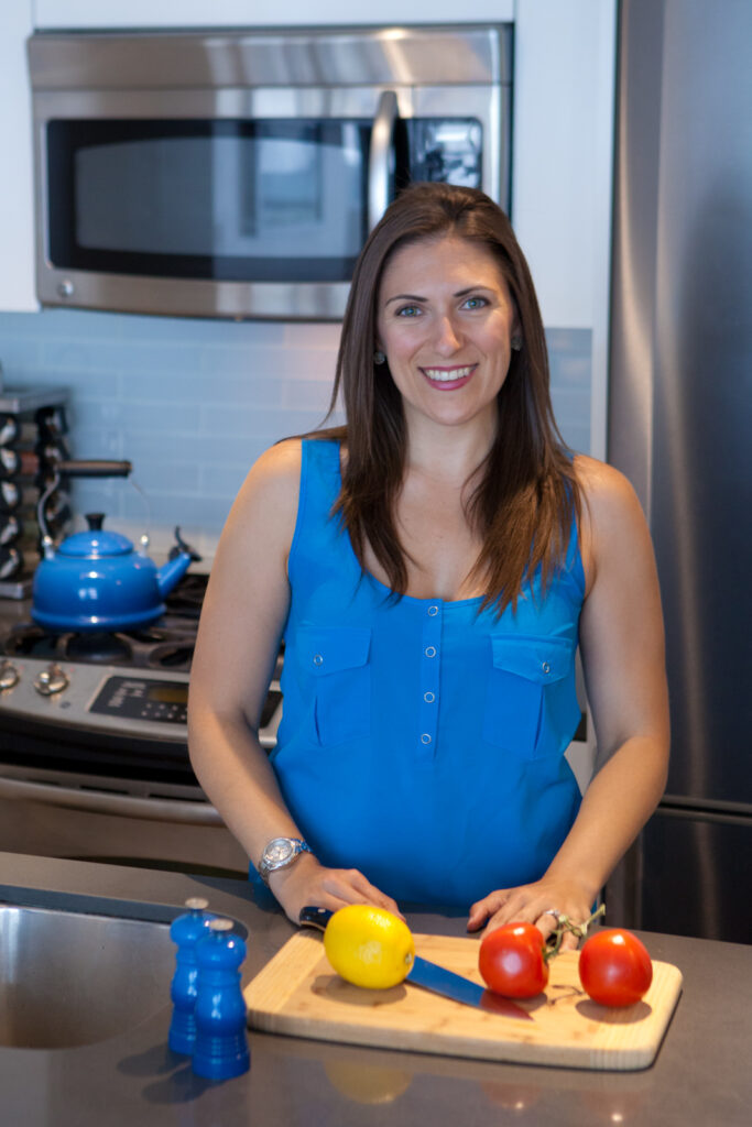 Alex wearing blue smiling in the kitchen
